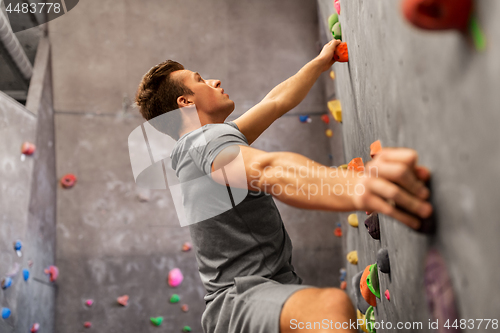 Image of young man exercising at indoor climbing gym
