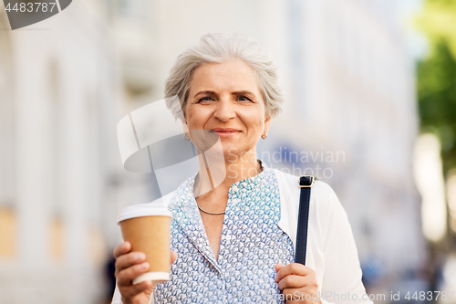 Image of senior woman drinking coffee at summer city