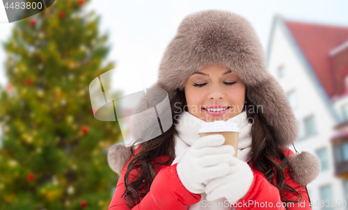 Image of woman with coffee over christmas tree in tallinn