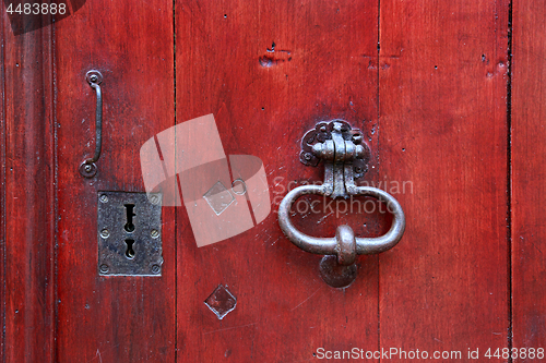 Image of Vintage door with metallic decorative knocker, handle and keyhol