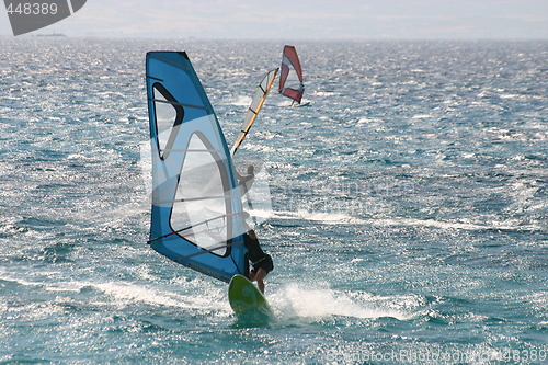 Image of Three windsurfers at sea