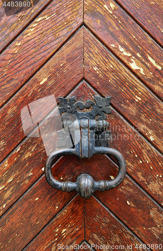 Image of Vintage knocker close-up on wooden door background