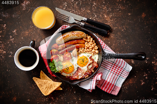 Image of Delicious english breakfast in iron cooking pan