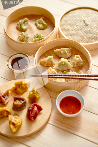 Image of Traditional chinese dumplings served in the wooden bamboo steamer