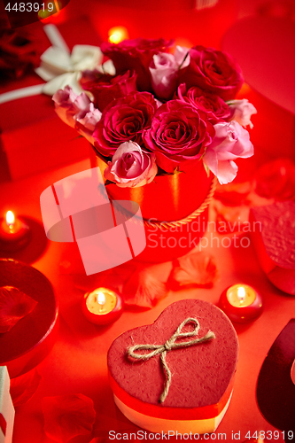 Image of Valentines day romantic decoration with roses, boxed gifts, candles