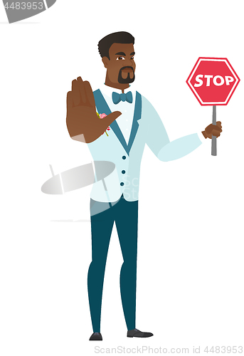 Image of African-american groom holding stop road sign.