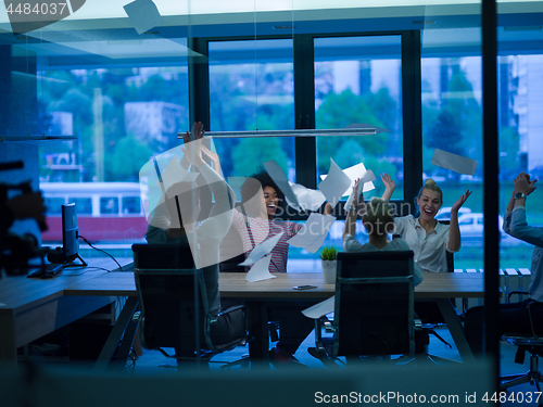 Image of multiethnic Group of young business people throwing documents