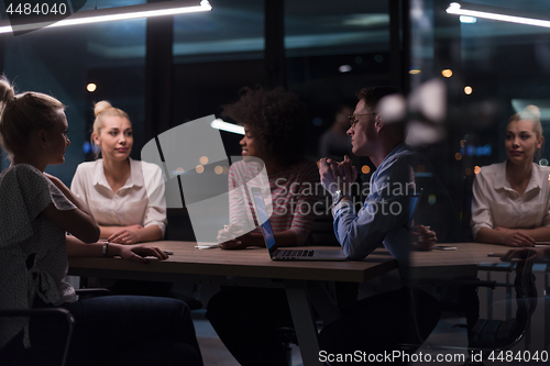 Image of Multiethnic startup business team in night office