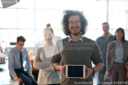 Image of Portrait of a young businessman holding tablet