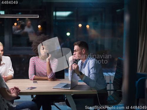 Image of Multiethnic startup business team in night office