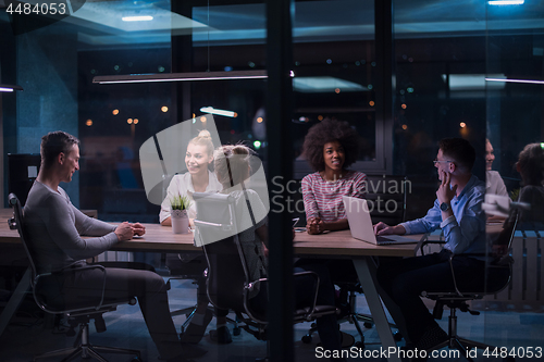 Image of Multiethnic startup business team in night office