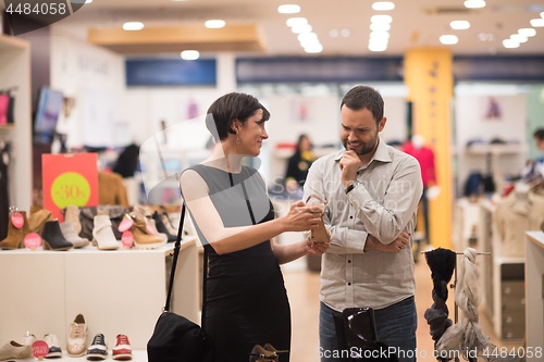 Image of couple chooses shoes At Shoe Store