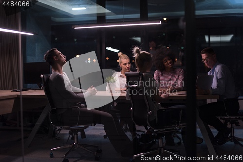 Image of Multiethnic startup business team in night office