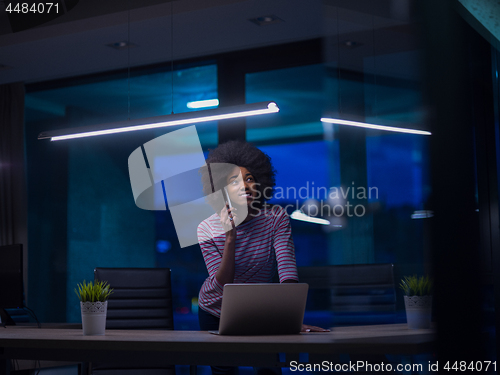 Image of black businesswoman using a laptop in startup office