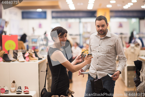 Image of couple chooses shoes At Shoe Store