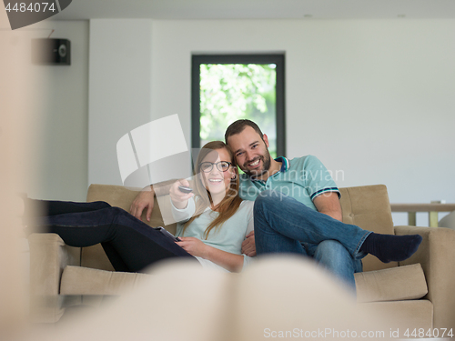 Image of Young couple on the sofa watching television