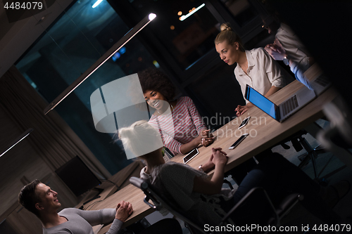 Image of Multiethnic startup business team in night office