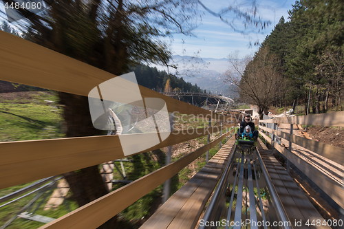 Image of father and son enjoys driving on alpine coaster