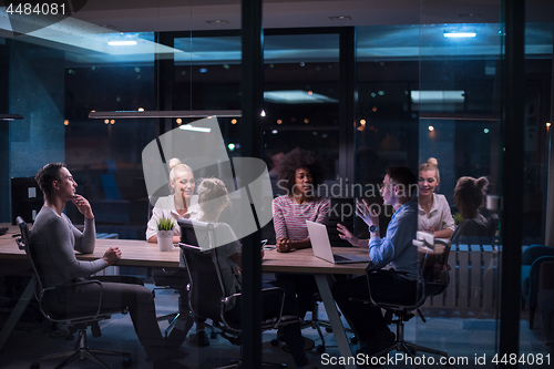 Image of Multiethnic startup business team in night office