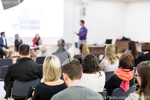 Image of Audience in lecture hall participating at business conference.