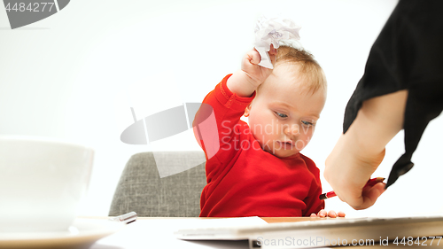 Image of Happy child baby girl toddler sitting with keyboard of computer isolated on a white background