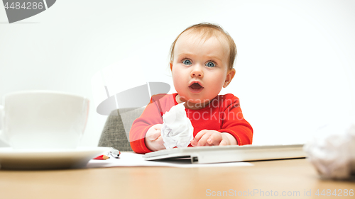 Image of Happy child baby girl toddler sitting with keyboard of computer isolated on a white background