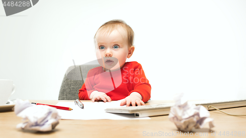 Image of Happy child baby girl toddler sitting with keyboard of computer isolated on a white background