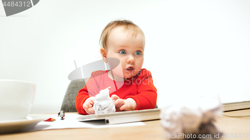 Image of Happy child baby girl toddler sitting with keyboard of computer isolated on a white background