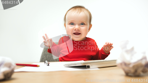 Image of Happy child baby girl toddler sitting with keyboard of computer isolated on a white background