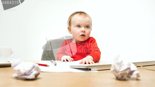 Image of Happy child baby girl toddler sitting with keyboard of computer isolated on a white background