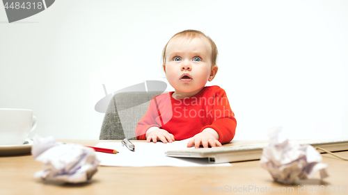 Image of Happy child baby girl toddler sitting with keyboard of computer isolated on a white background