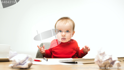 Image of Happy child baby girl toddler sitting with keyboard of computer isolated on a white background