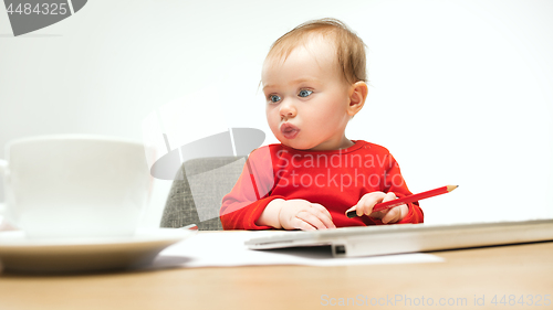 Image of Happy child baby girl toddler sitting with keyboard of computer isolated on a white background