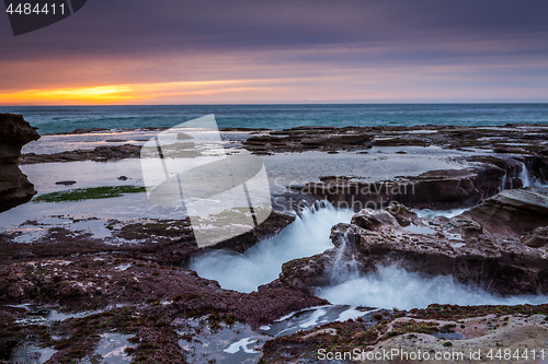 Image of Ocean eroding out channels in the rocks