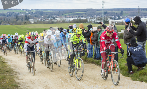 Image of The Peloton on a Dirty Road - Paris-Nice 2016