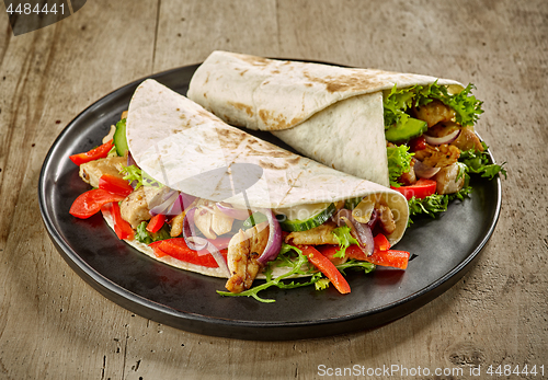 Image of Tortilla wraps with fried chicken meat and vegetables