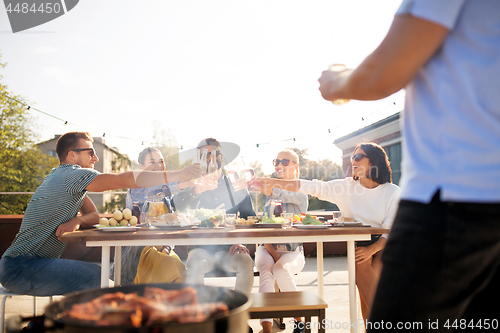 Image of friends toast drinks at barbecue party on rooftop