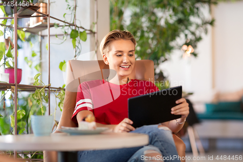 Image of happy woman with tablet pc at cafe or coffee shop