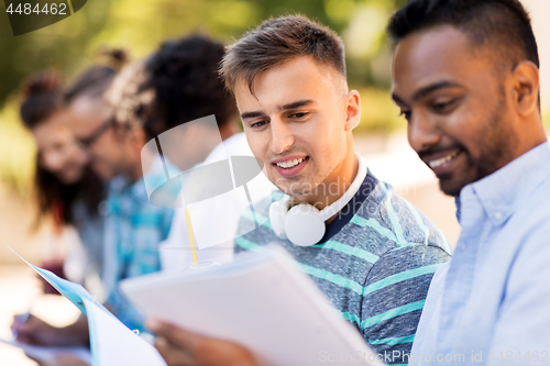 Image of students with notebook outdoors