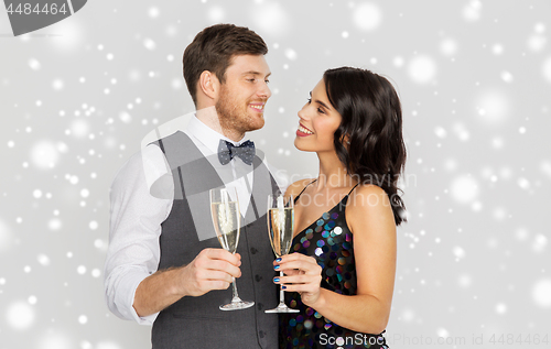 Image of happy couple with champagne celebrating christmas