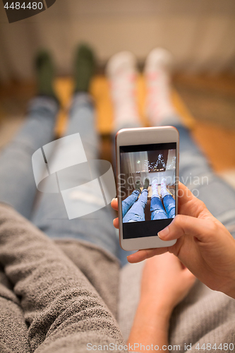 Image of close up of couple taking foot photo by smartphone
