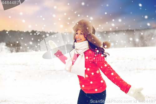 Image of happy woman in fur hat over winter background