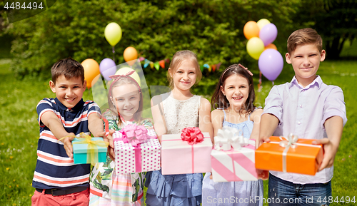 Image of happy kids with gifts on birthday party at summer