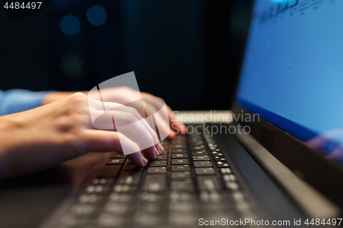 Image of close up of female hands with laptop typing