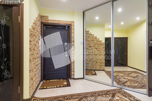 Image of Spacious entrance hall in the apartment with built-in wardrobe and huge mirrors