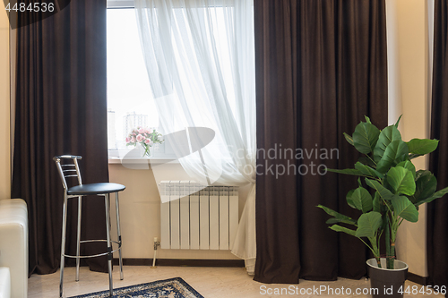 Image of Interior element, bar stool, curtain windows, vase with flowers on the window