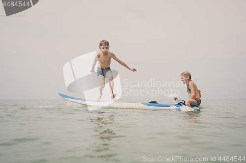 Image of Happy children playing on the beach at the day time.