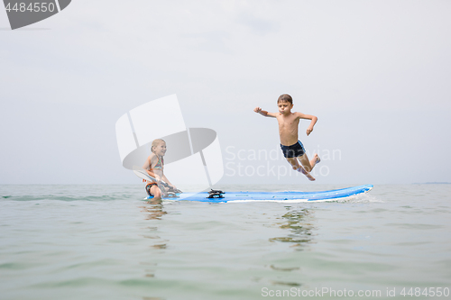 Image of Happy children playing on the beach at the day time.