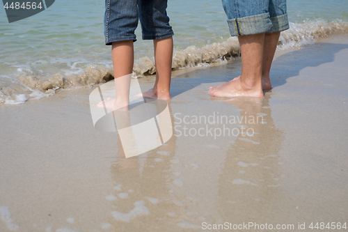 Image of Father and son playing on the beach at the day time.