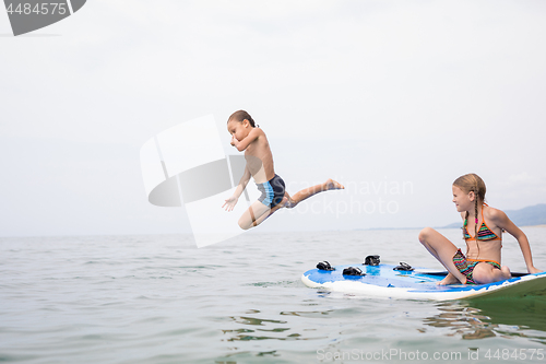 Image of Happy children playing on the beach at the day time.